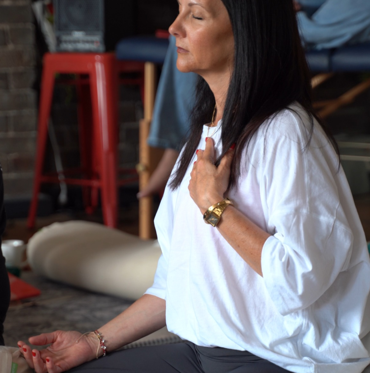 Michelle in meditation, hand to heart